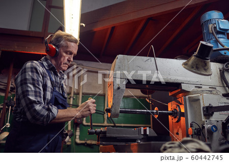Operator working on lathe Operator working on lathe 60442745