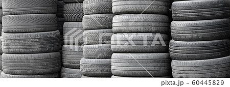Old used tires stacked with high piles in 60445829