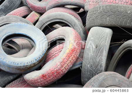 A picture of many old used tires left on a waste A picture of many old used tires left on a waste 60445863