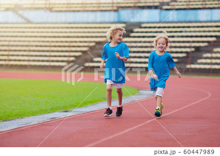 Child running in stadium. Kids run. Healthy sport. 60447989