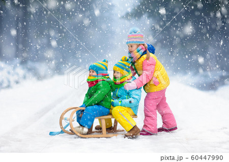 Kids play in snow. Winter sleigh ride for children 60447990