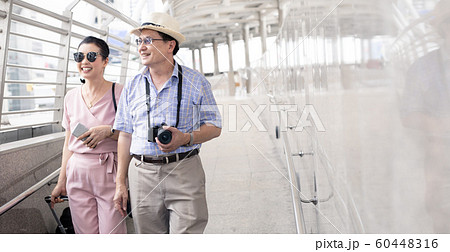 Senior Asian couple with a woman dragging a Senior Asian couple with a woman dragging a 60448316