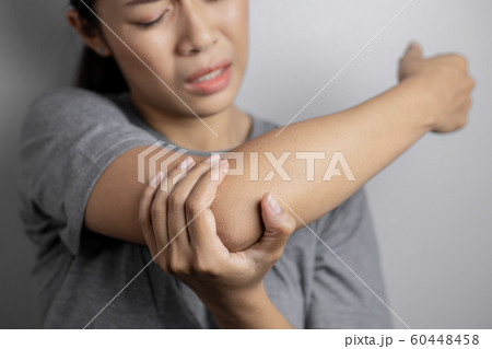 Women with pain in elbow. Women with pain in elbow. 60448458
