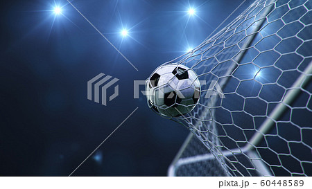 Soccer ball flew into the goal. Soccer ball bends the net, against the background of flashes of light. Soccer ball in goal net on blue background. A moment of delight. 3D illustration 60448589