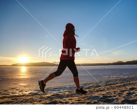 Runner woman feet running on offshore. Female Runner woman feet running on offshore. Female 60448921