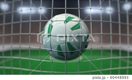 Football with flags of Nigeria in net against blurred stadium. Conceptual 3D rendering Football with flags of Nigeria in net against blurred stadium. Conceptual 3D rendering 60448993