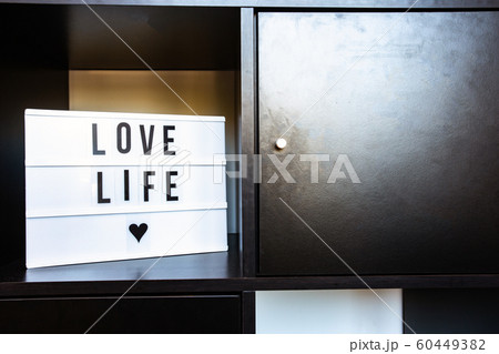 Sign, Love life on black wooden shelf, modern decoration in retro home clean interior Sign, Love life on black wooden shelf, modern decoration in retro home clean interior 60449382