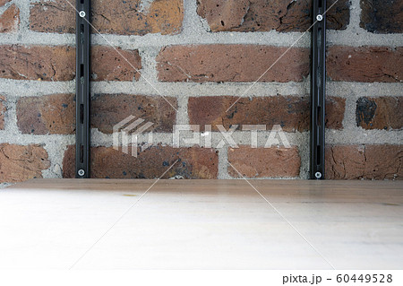 Empty wood shelf on old brick wall background, grunge industrial interior background texture Empty wood shelf on old brick wall background, grunge industrial interior background texture 60449528