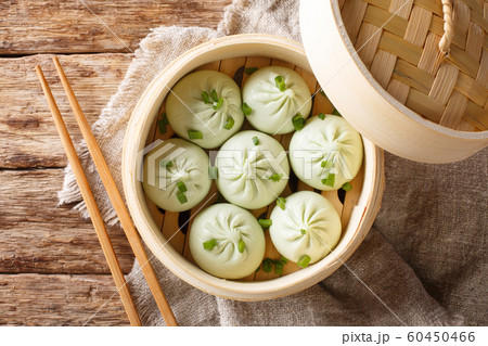 Traditional chinese baozi steam buns in a bamboo Traditional chinese baozi steam buns in a bamboo 60450466