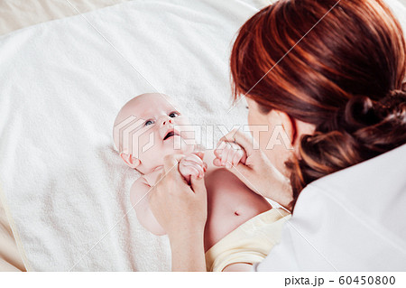the little boy baby mother doing massage hands and legs the little boy baby mother doing massage hands and legs 60450800
