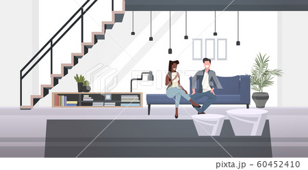 mix race businesspeople couple sitting on couch man woman discussing during meeting modern office waiting room interior horizontal full length 60452410