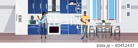 woman using rag man mopping floor family doing housework cleaning service concept modern kitchen interior horizontal full length 60452437