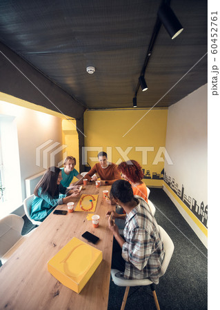 Freelancers enjoying their break while playing table game Freelancers enjoying their break while playing table game 60452761
