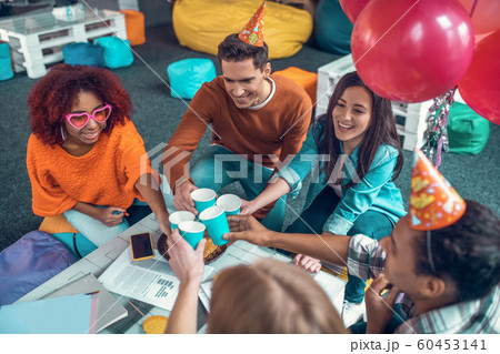 Students wearing birthday hats having birthday party after studying 60453141
