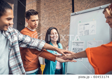 Student holding birthday cake while congratulating friend Student holding birthday cake while congratulating friend 60453174