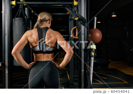 sport, fitness, lifestyle and people concept - woman exercising and doing pull-ups in gym from back sport, fitness, lifestyle and people concept - woman exercising and doing pull-ups in gym from back 60454041