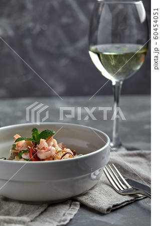 Rice noodles with shrimps and seafood, spicy asian style noodles in bowl. Rice noodles with shrimps and seafood, spicy asian style noodles in bowl. 60454051