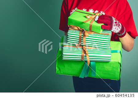 Girl holding a boxes with a gift for Christmas 2019. Girl holding a boxes with a gift for Christmas 2019. 60454135