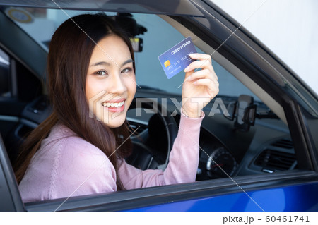 Happy beautiful Asian woman sitting inside new car 60461741