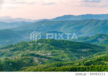 Layers of mountains in the haze during sunset. 60463211