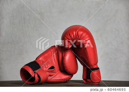 Pair of red boxing gloves on a white background. 60464693
