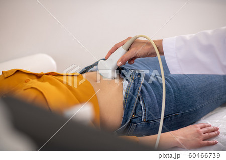 Female doctor making ultrasound test to pregnant woman 60466739