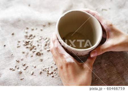Female hands hold a bowl for casting clay products. Female hands hold a bowl for casting clay products. 60466759