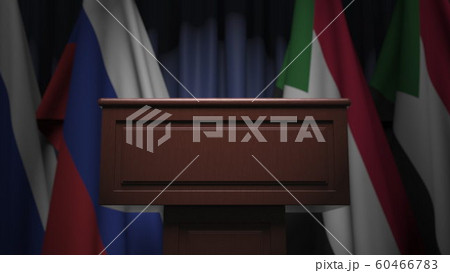 Many flags of Sudan and Russia behind speaker tribune, 3D rendering 60466783
