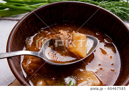 Close up view of clay plate and spoon with red 60467585