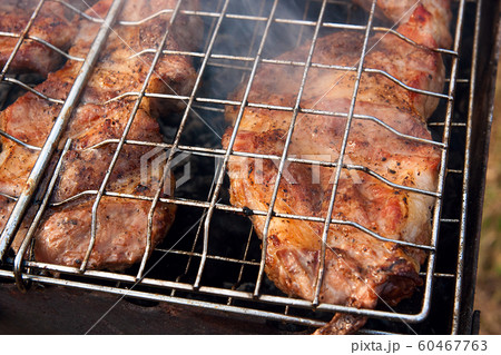 Close up view of juicy pork steak cooking on an Close up view of juicy pork steak cooking on an 60467763