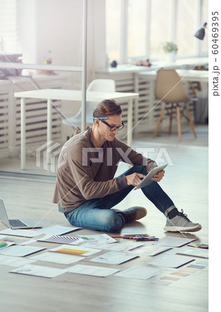 Adult Businessman Sitting on Floor in Office 60469395