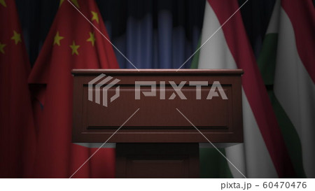Row of flags of Hungary and China and and speaker tribune, conceptual 3D rendering 60470476