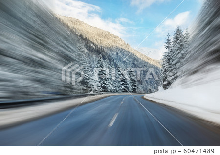 Winter alpine road curve landscape with forest, mountains and blue sky on background at bright cold sunny day. Car trip family travel journey. Holiday skiing vacation. scenic austrian landscape 60471489