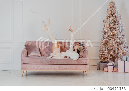 Beautiful woman is lying on the sofa. Beautiful woman is lying on the sofa. 60473578