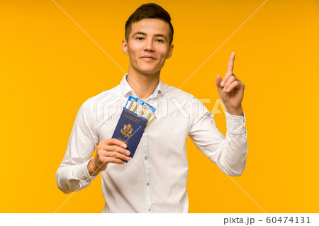 A handsome asian man in a white shirt rejoices in 60474131