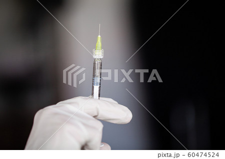 Syringe. Doctor Prepared Syringe of Vaccine to Injunction Patient Syringe. Doctor Prepared Syringe of Vaccine to Injunction Patient 60474524