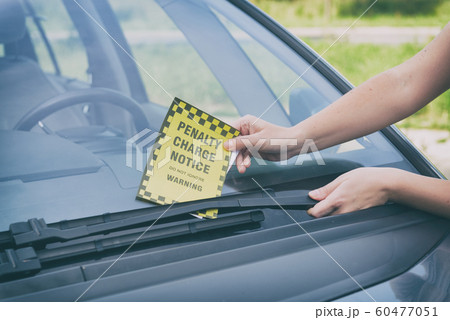 Parking ticket under windshield wiper Parking ticket under windshield wiper 60477051