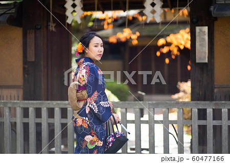 Geishas girl wearing Japanese kimono among red Geishas girl wearing Japanese kimono among red 60477166