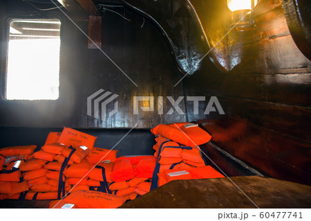 orange life vest on wooden background 60477741