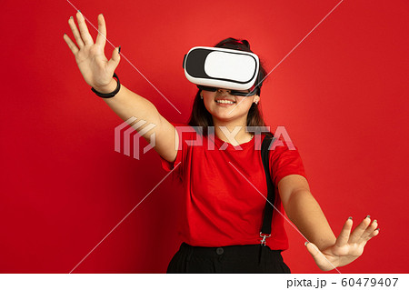 Asian teenager's portrait isolated on red studio background 60479407