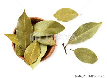 Dried bay leaf in a wooden plate on a white Dried bay leaf in a wooden plate on a white 60479873