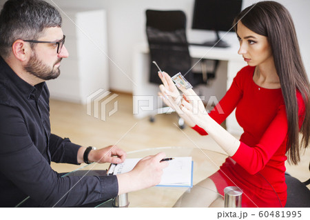 Business. Business Woman Gives Money to Men. Woman Dressed in Red Dress Gives Bribe. Business Man In Gray Jacket Gets Bribe. High Resolution 60481995