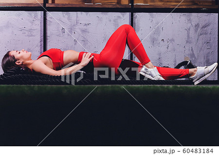 Athletic young woman doing some exercises with a rope outdoor. 60483184