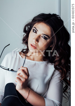 beautiful girl with Hat and glasses in the Studio curls hairstyle 60483975