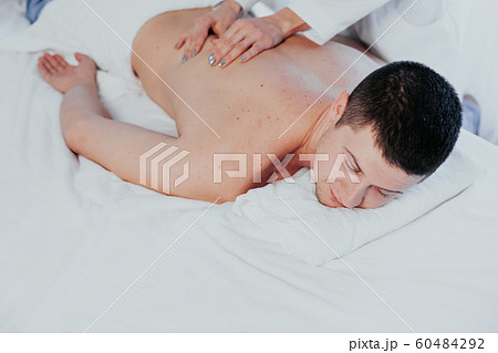 a massage therapist makes a man massage spa treatment health 60484292