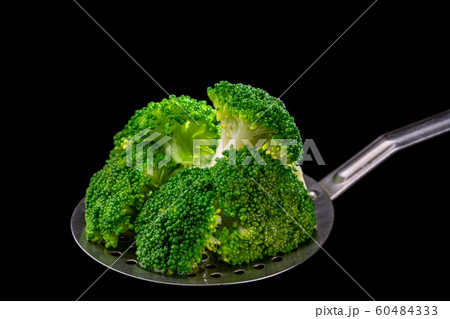 Fresh broccoli on a spoon scoop, ready for use by vegetarians 60484333