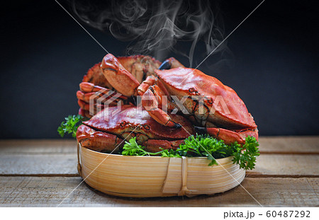 Cooked crab on steamer and dark background - 60487292
