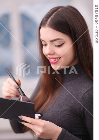Beauty Girl with Makeup Brush. Natural Make-up for Brunette 60487810