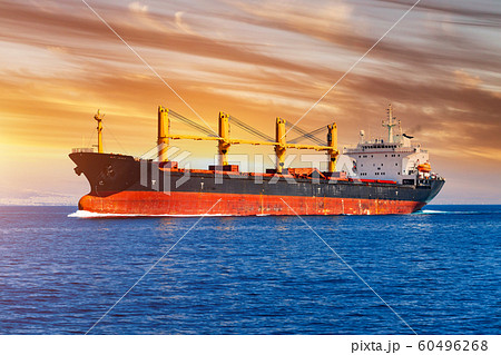 Cargo ship at sea at sunset. Logistics and cargo transportation. Cargo ship at sea at sunset. Logistics and cargo transportation. 60496268