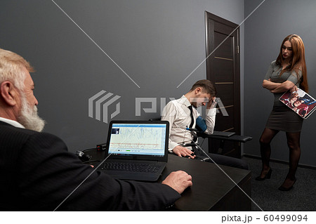 Sad man answering questions during lie detector test 60499094